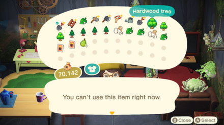 ACNH - A player selects a Hardwood tree in their pockets