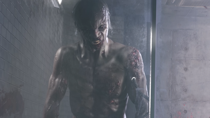 An angry zombie seen in the Dying Light: The Beast trailer angrily staring at the player character from behind a laboratory