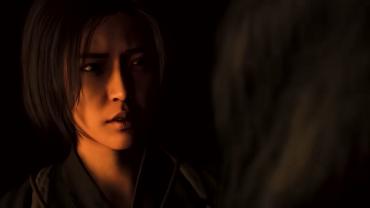 This screenshots shows Assassin’s Creed Shadows’ Naoe in a dimly lit room speaking to a mysterious figure