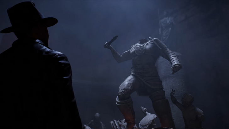 Indiana Jones looking at a beheaded giant statue