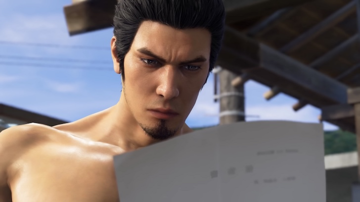 Kazuma Kiryu reading a sheet of paper