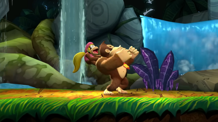 A smiling Dixie riding at the back of Donkey Kong in a mid chest-thumping pose, both inside a tropical-themed stage that has plants and waterfalls