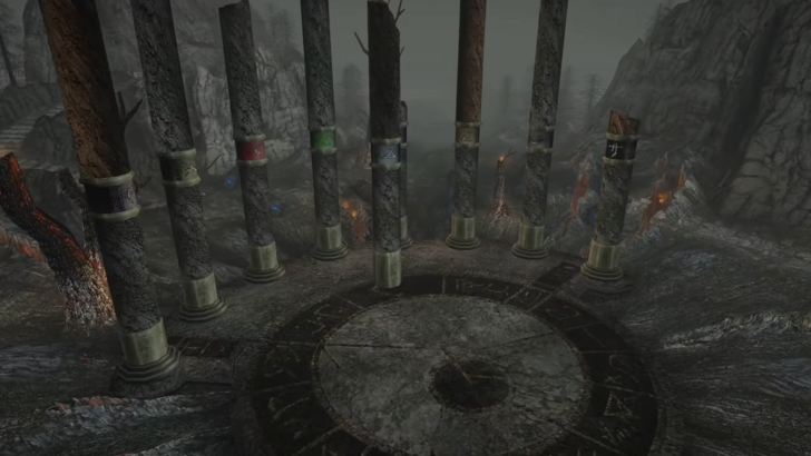 Pillars that circle an altar with symbols sculpted on the ground, misty woods with dead trees and gray rock formations