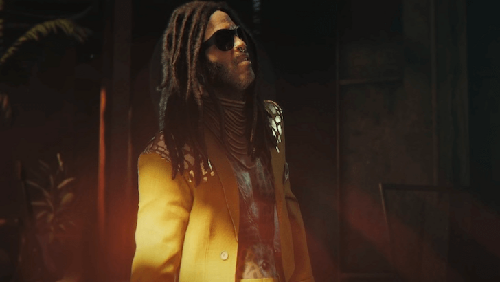 Bawma standing, showing his yellow suit with details on the shoulder