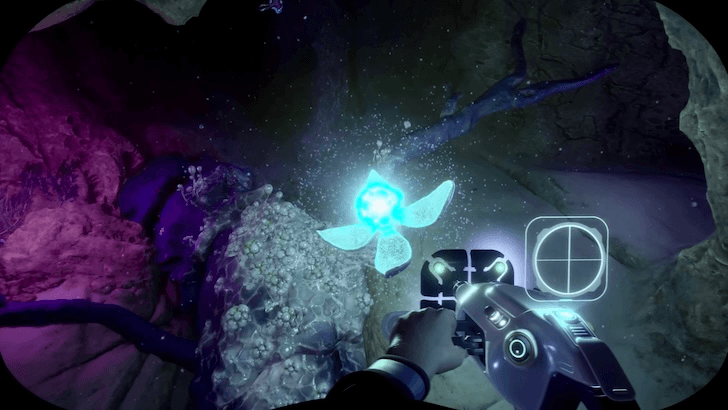 Diver scanning glowing organism