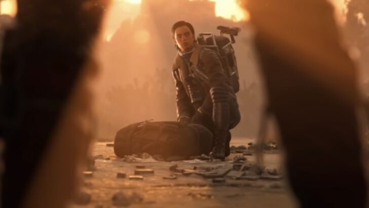 ARC Raiders character crouching beside gear