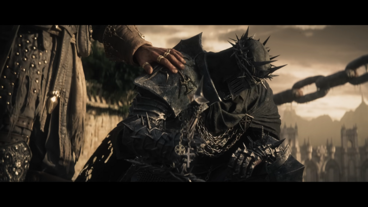 Lords of the Fallen 2 protagonist in full armour, a hand placed on their right shoulder