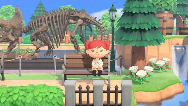 A player sitting near a fossil exhibit decor