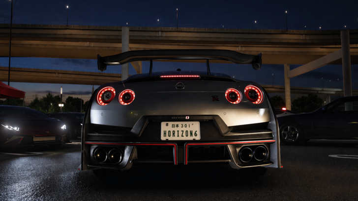 Forza Horizon 6 Rear view of a Nissan GT R parked under an overpass at night with glowing taillights