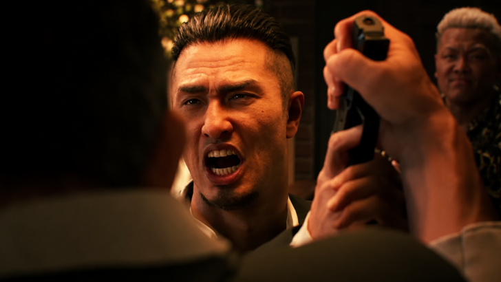 GANG OF DRAGON A man shouts during a tense gunpoint confrontation