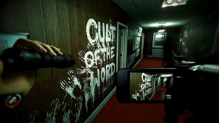 Player filming graffiti in a hallway