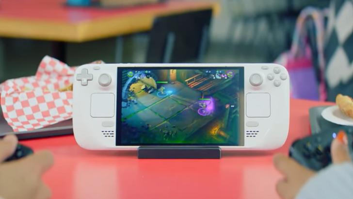 Steam Deck displays a game while two players use Steam Controllers at a table
