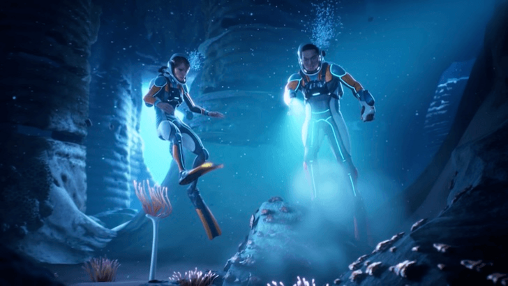 Two divers explore a dark underwater cave
