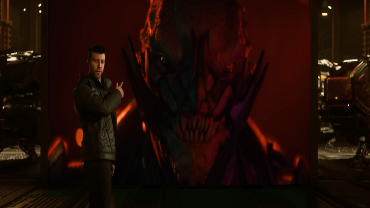 Star Citizen A man presents a red-lit alien figure on a large screen