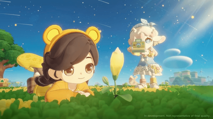 Two Petit Planet characters admire a glowing flower