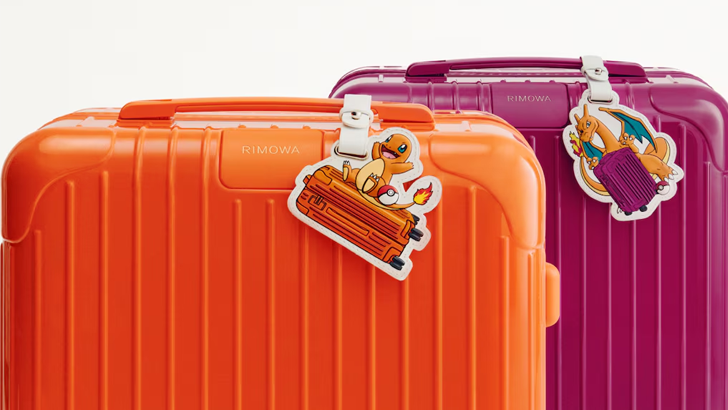 pokemon rimowa orange luggage with charmander tag and purple luggage with charizard tag