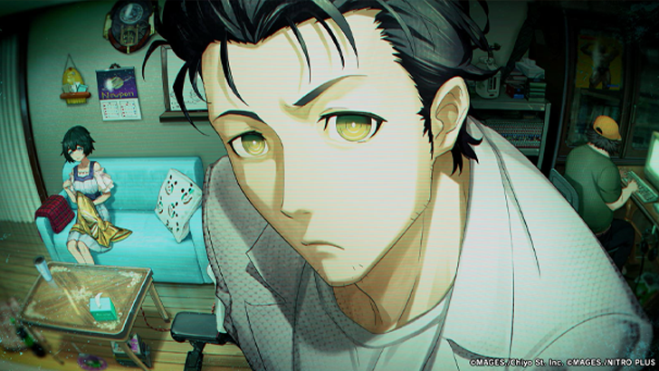guy in white shirt with black hair and yellow eyes looking up into camera with black haired girl sitting on blue couch in background