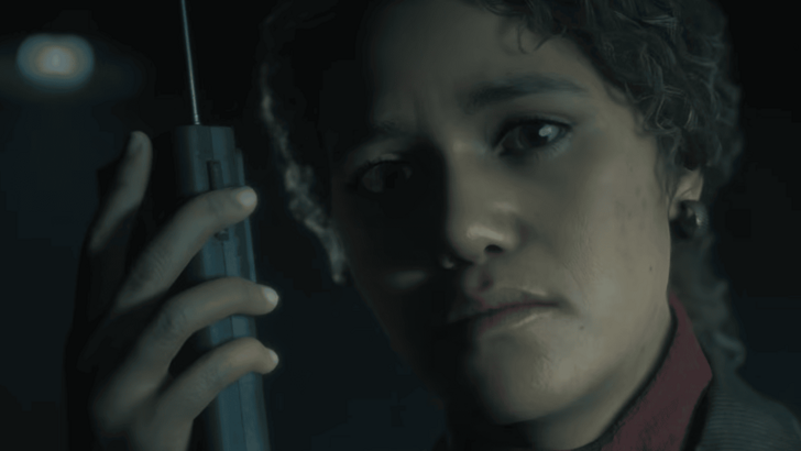 Ghost hunter holds up a walkie talkie